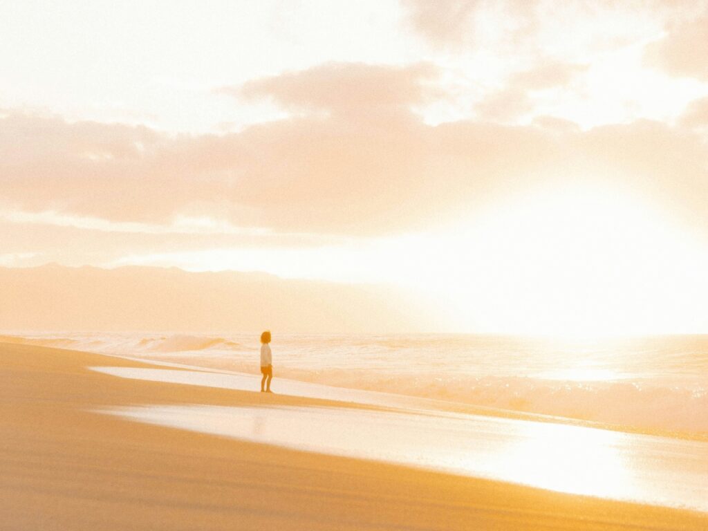 ชายหาดโล่ง ๆ มีคนเดินอยู่ตัวเดียวไกล ๆ